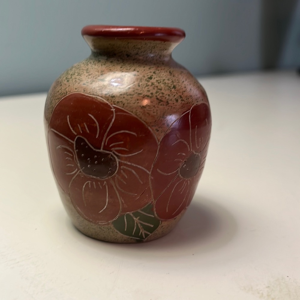 Beautiful small vase with red flowers.